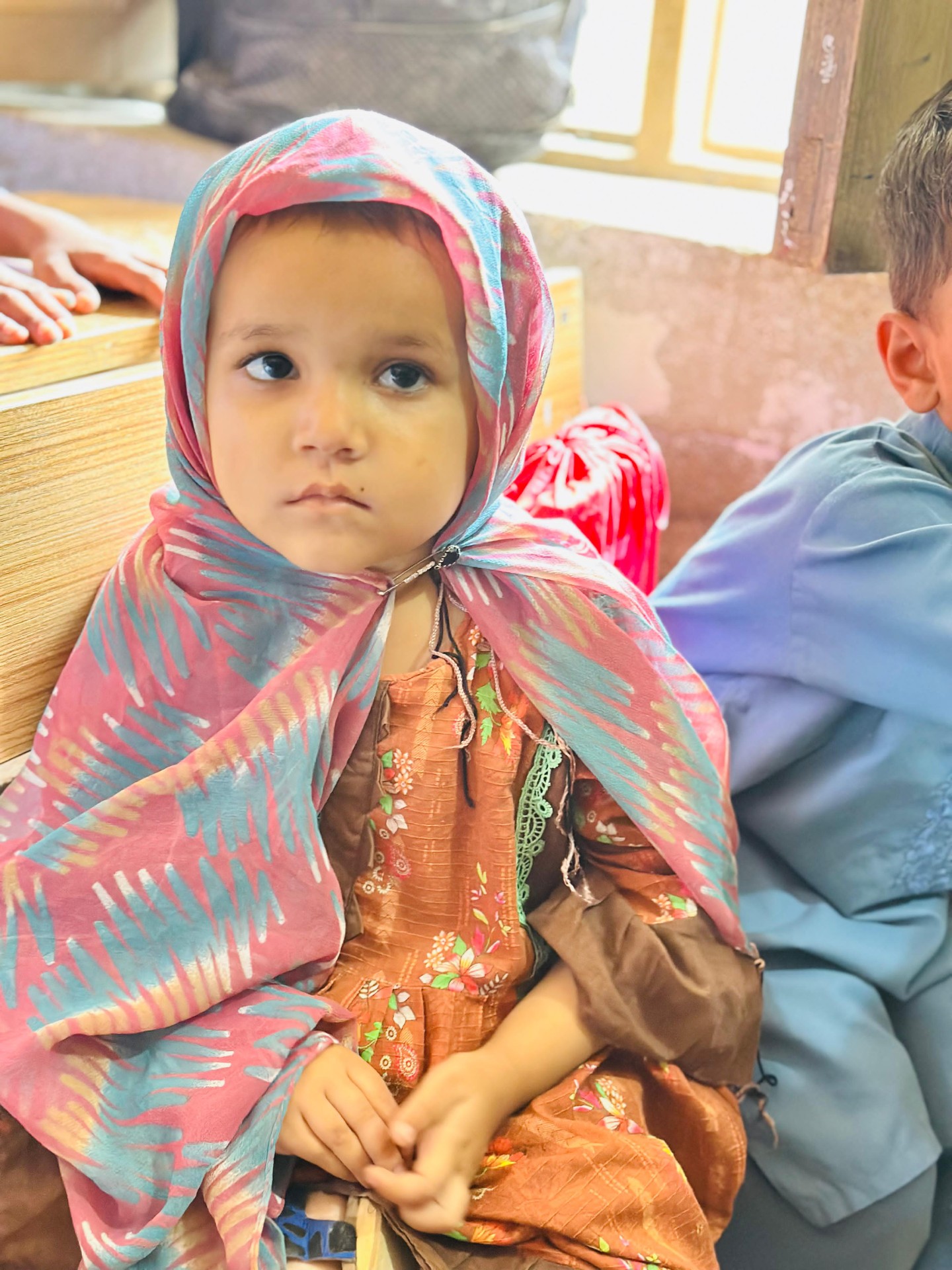 Young Pakistani child waits her turn during a school vision screening day