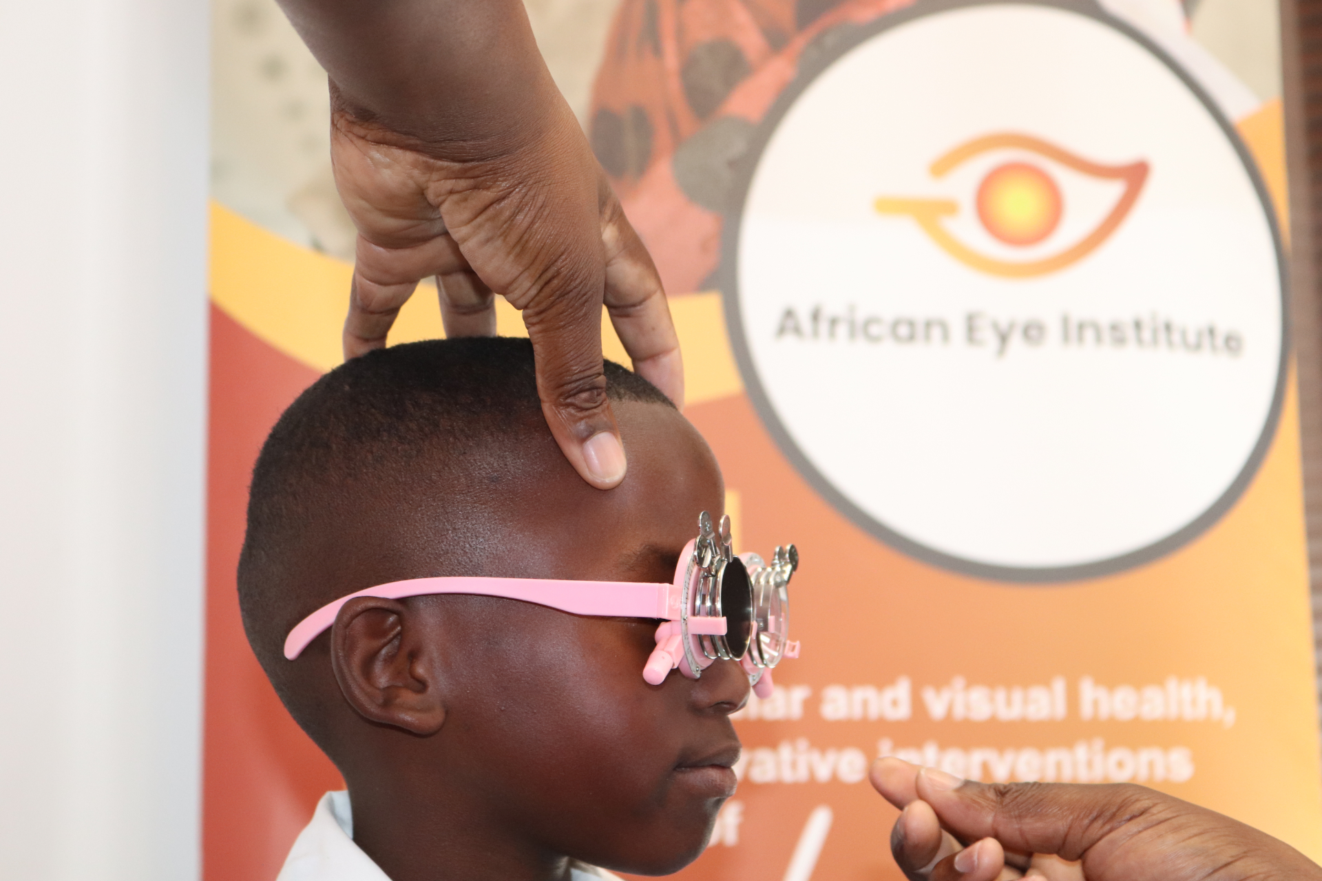 A learner undergoes a refraction test using a trial frame during an AEI–OGS funded outreach clinic at Umyezo Wama Apile Primary