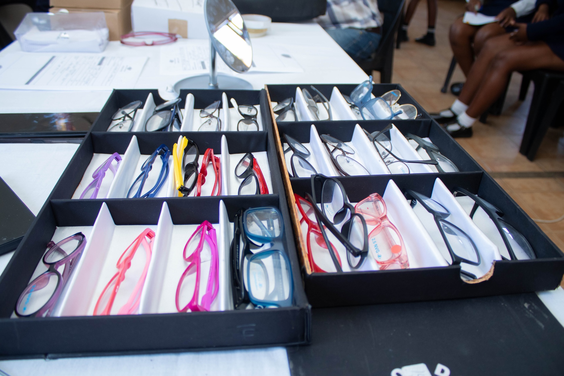 Tray of prescription frames ready for fitting at a South African school